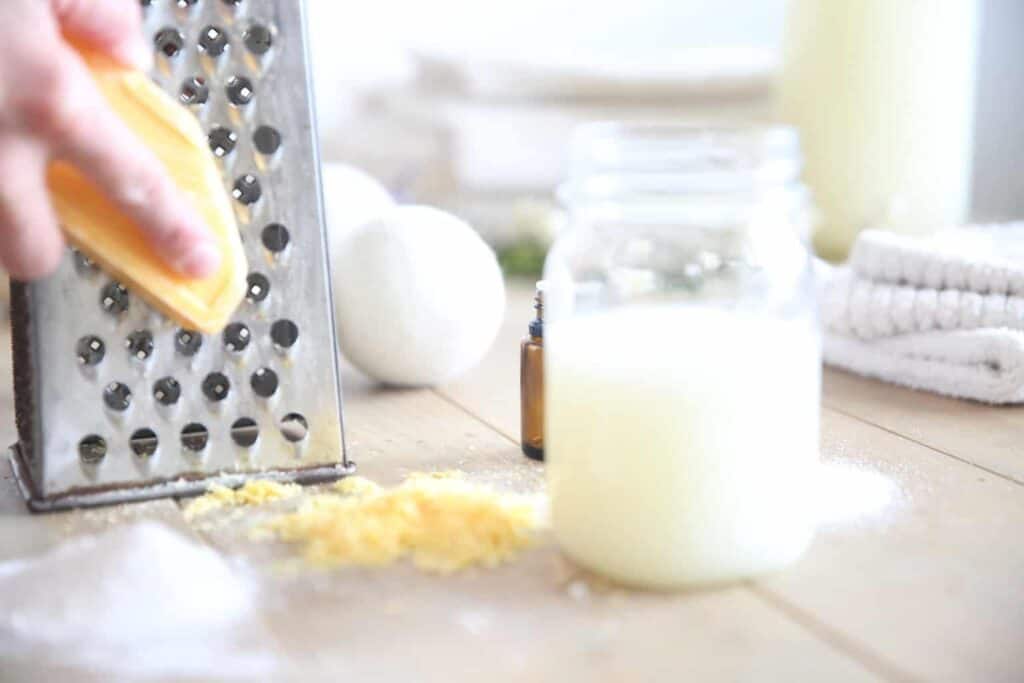 Shredding a soap bar to make laundry detergent.