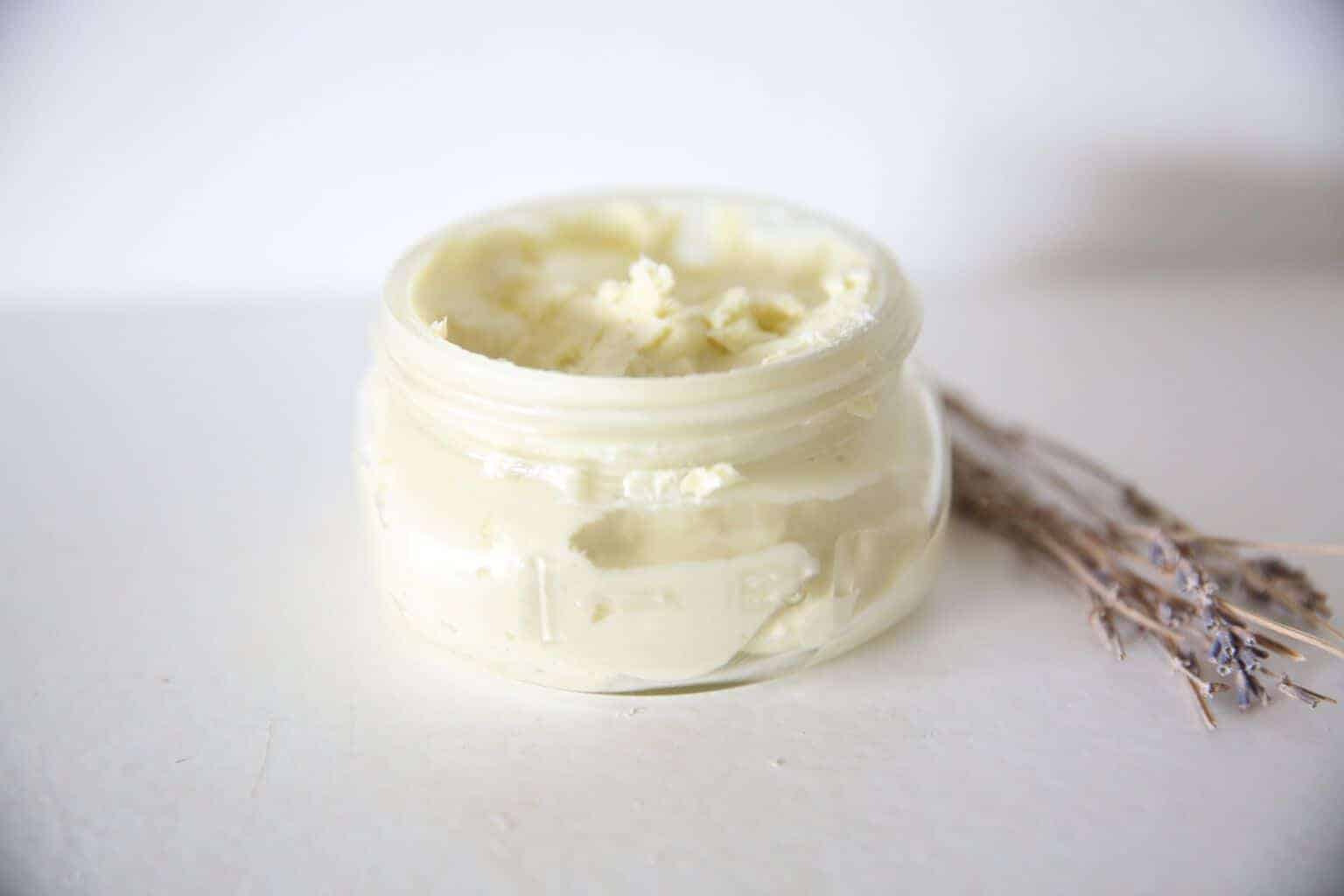 DIY whipped body butter cooling in a glass storage jar.