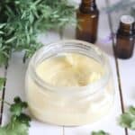 Whipped body butter in a glass travel container.