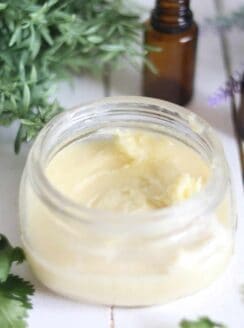 Whipped body butter in a glass travel container.