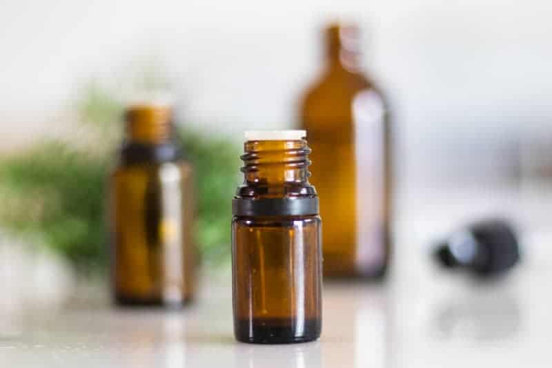 bug repellent oil bottles on white marble