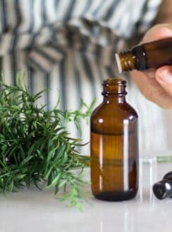 hand dropping essential oils into spray bottle