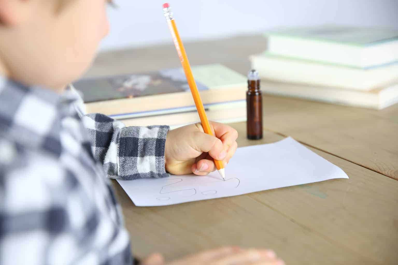 little boy staying focused while doing homework