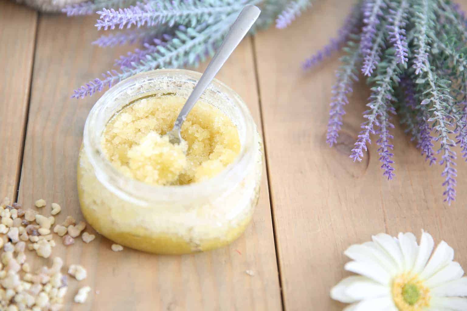 DIY sugar scrub on wooden table top with lavender sprigs