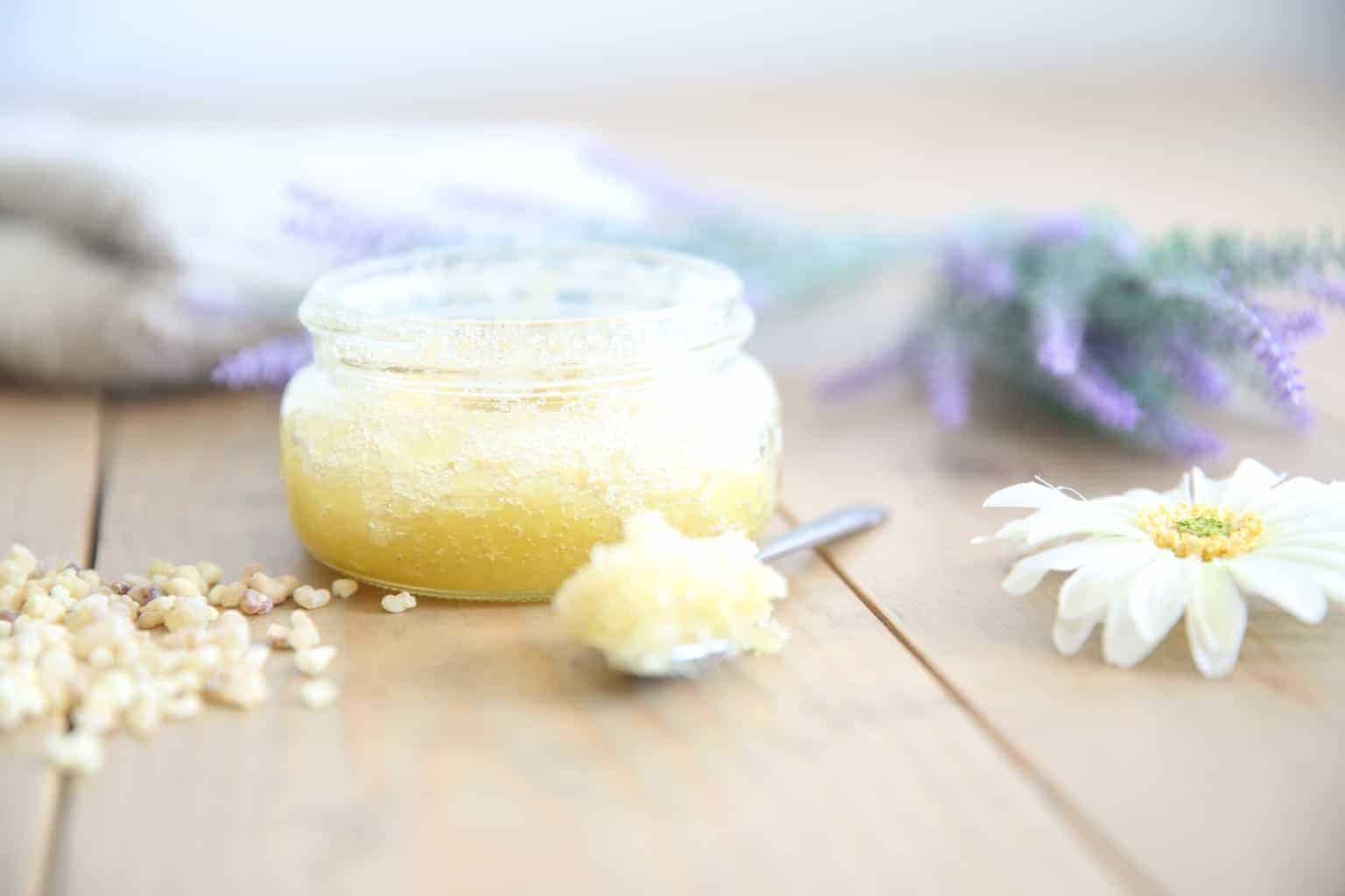 Homemade sugar scrub on wooden table.