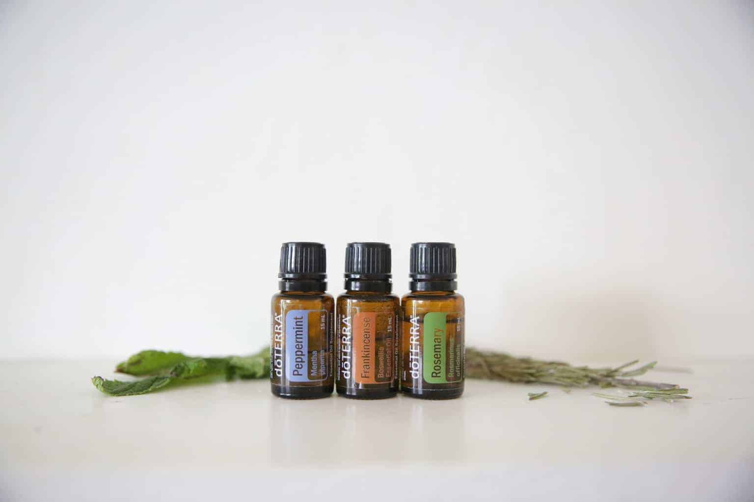 essential oil bottles with rosemary leaves