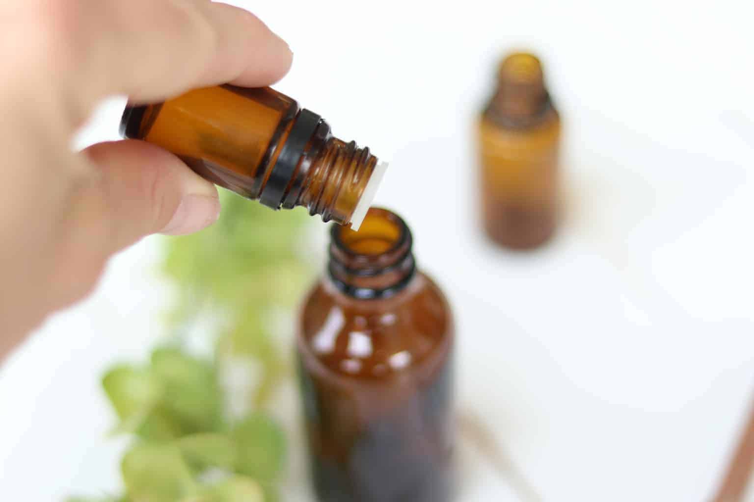 dropping essential oils into febreze spray bottle