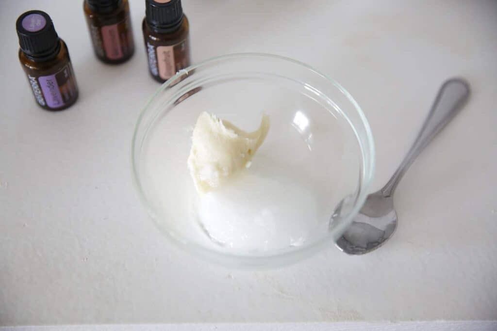 Homemade deodorant stick being made by melting down shea butter in a glass bowl.