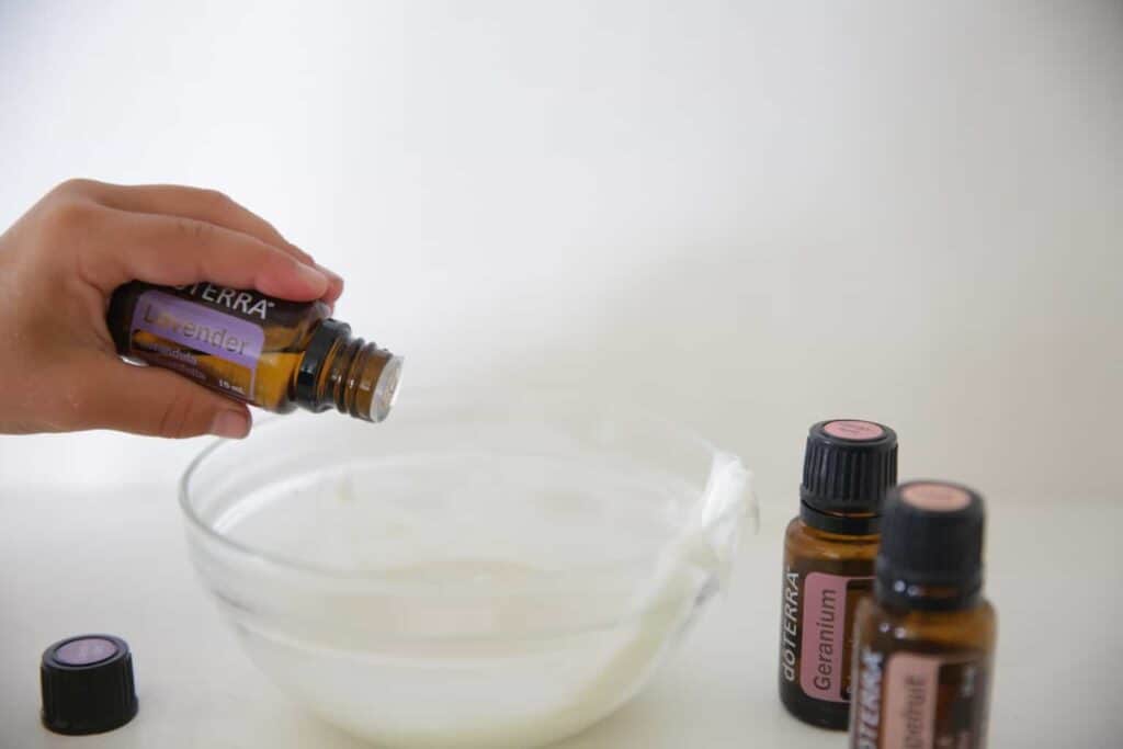 Adding lavender essential oil to the melted diy natural deodorant.