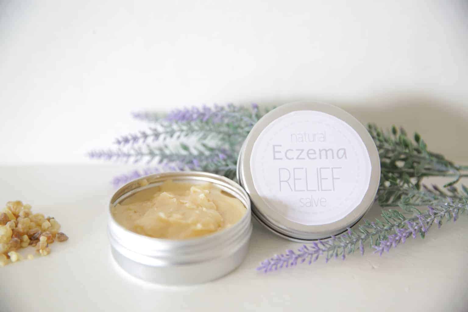 homemade healing salve in small metal container with lavender springs