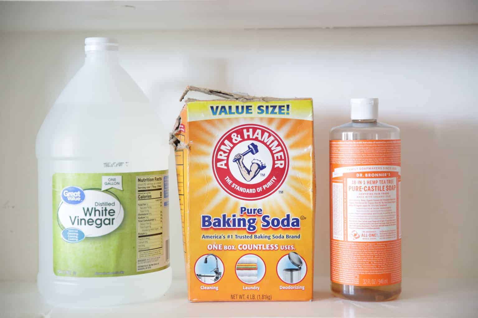 containers of white vinegar, baking soda and Castile soap