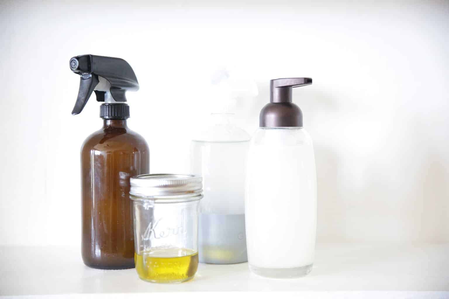 natural homemade cleaners in spray bottles jars and soap dispensers