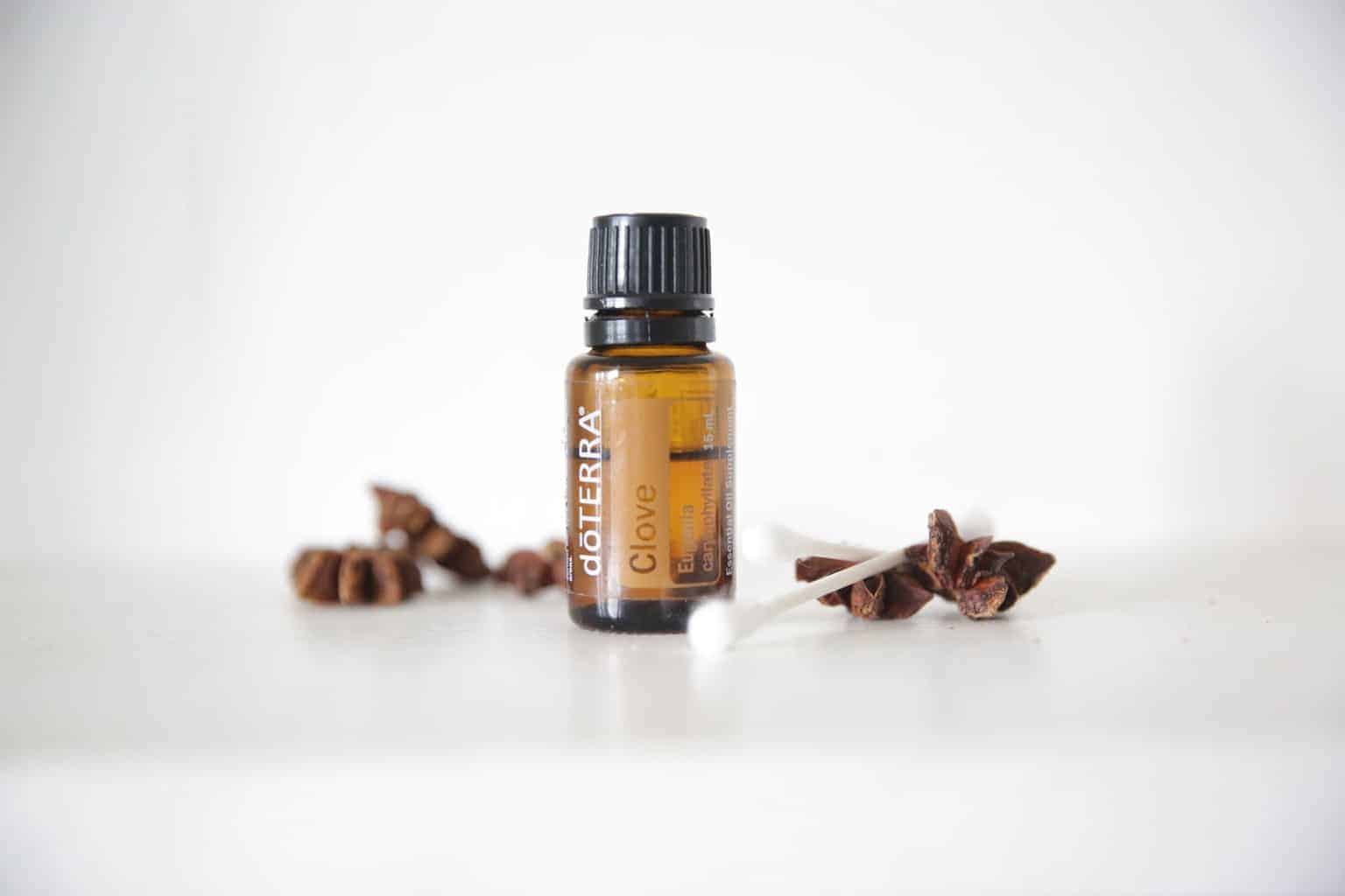 doTERRA clove essential oil bottle with dried cloves and a q tip