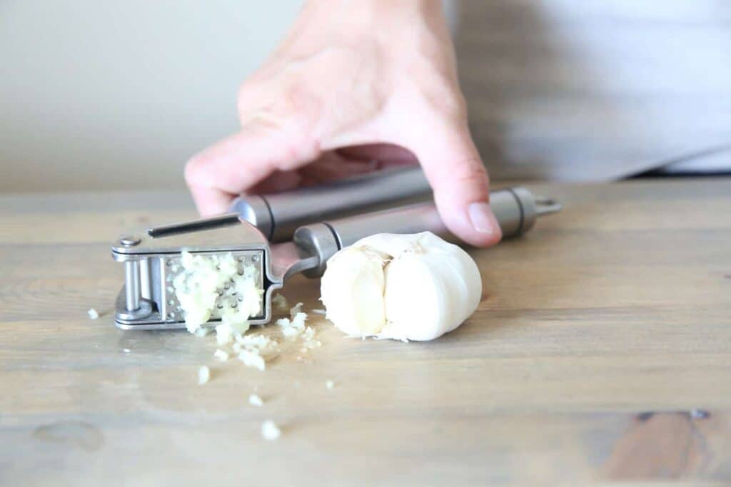 Mincing garlic for natural ear discomfort relief.