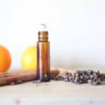 Cinnamon essential oils roller bottle with dried cinnamon.