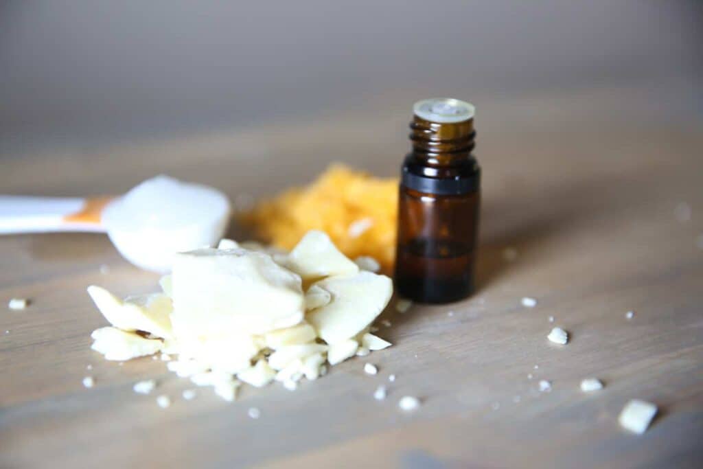 Homemade lip balm ingredients with an essential oil dropper.