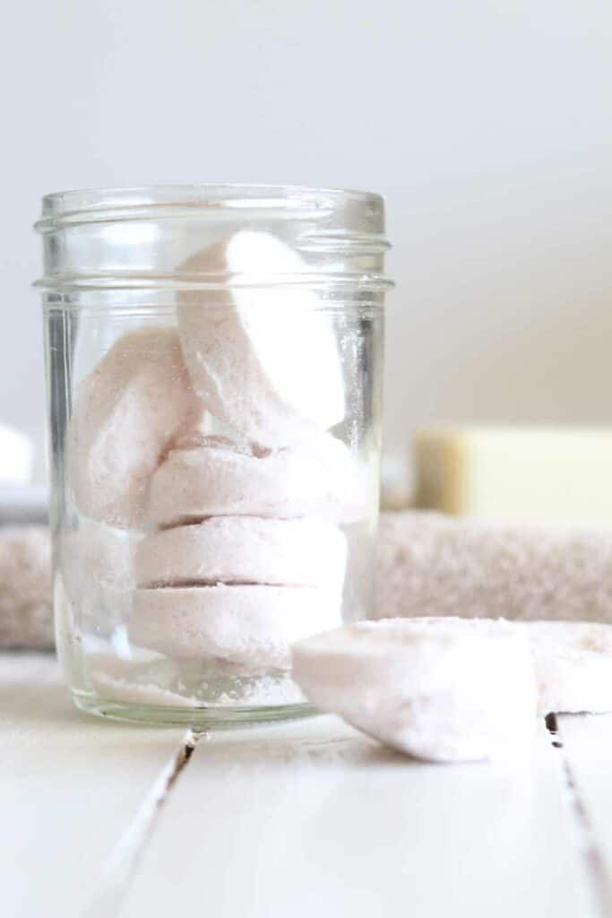 Homemade aromatherapy shower melts in glass airtight container.