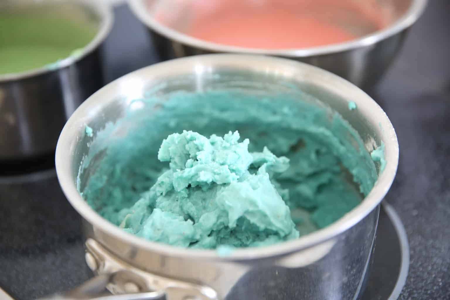 almost finished blue play dough on stove top in medium pot