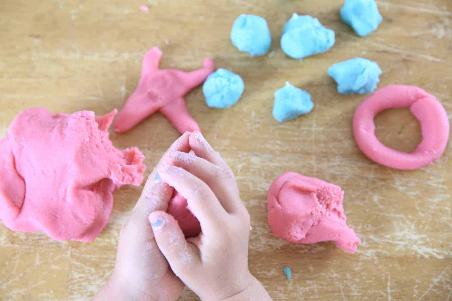 rolling homemade playdough into a ball