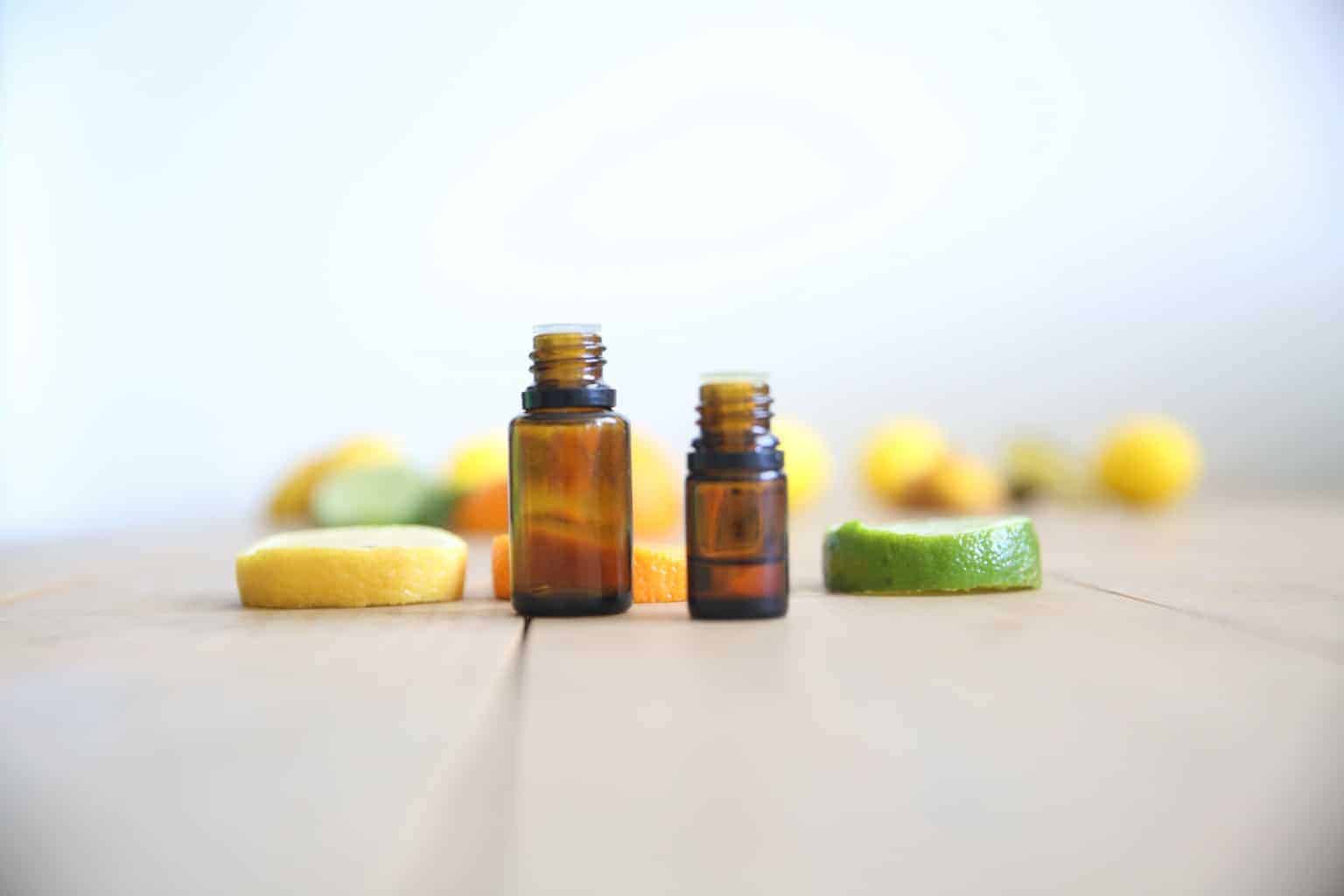 citrus essential oil bottles with sliced lemon and lime