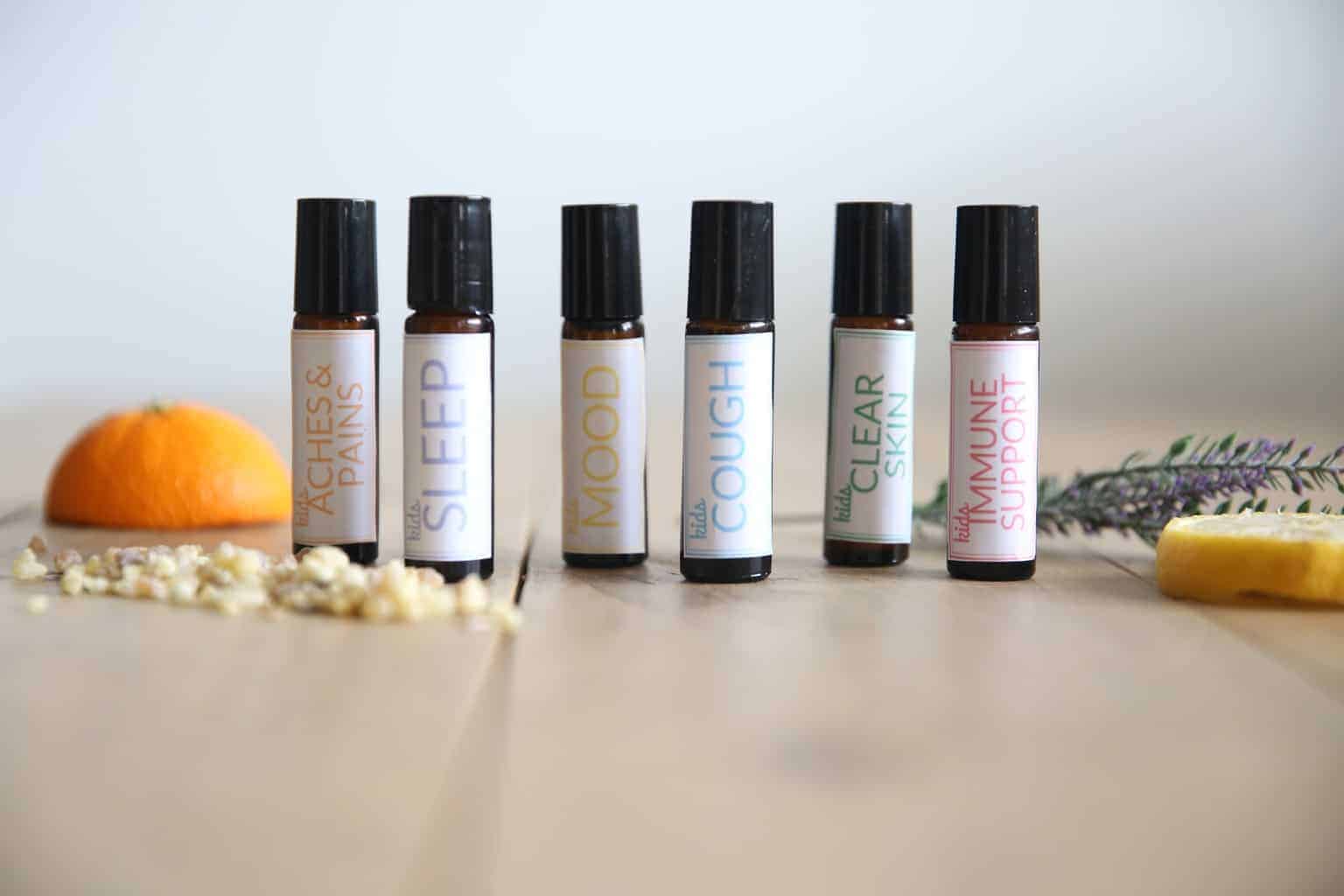 Essential oil blends for kids in 10mL roller bottles with homemade printable labels.