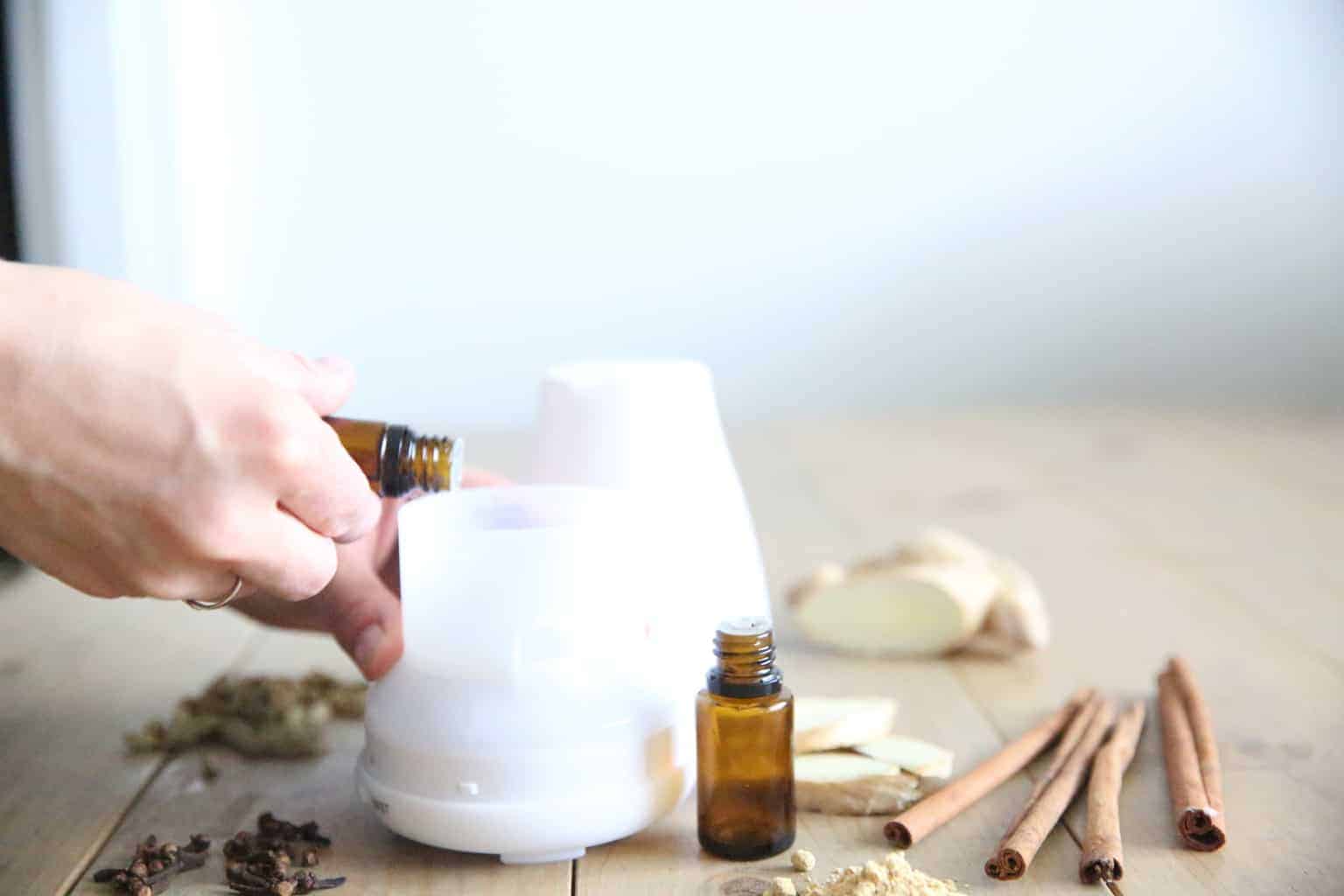 adding ginger essential oil to a small diffuser