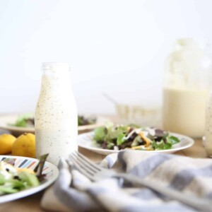 Homemade ranch dressing in a glass long neck salad dressing jar.