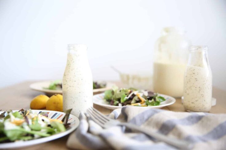 Homemade ranch dressing in a glass long neck salad dressing jar.