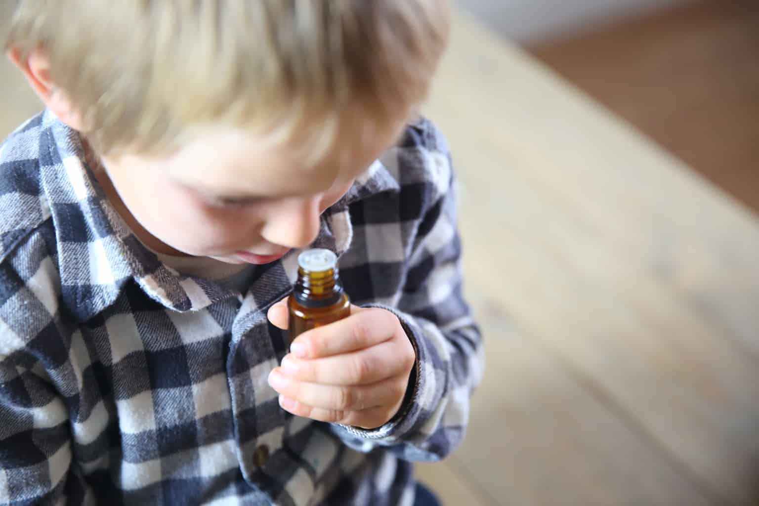 little boy sniffing a essential oil diffuser blend