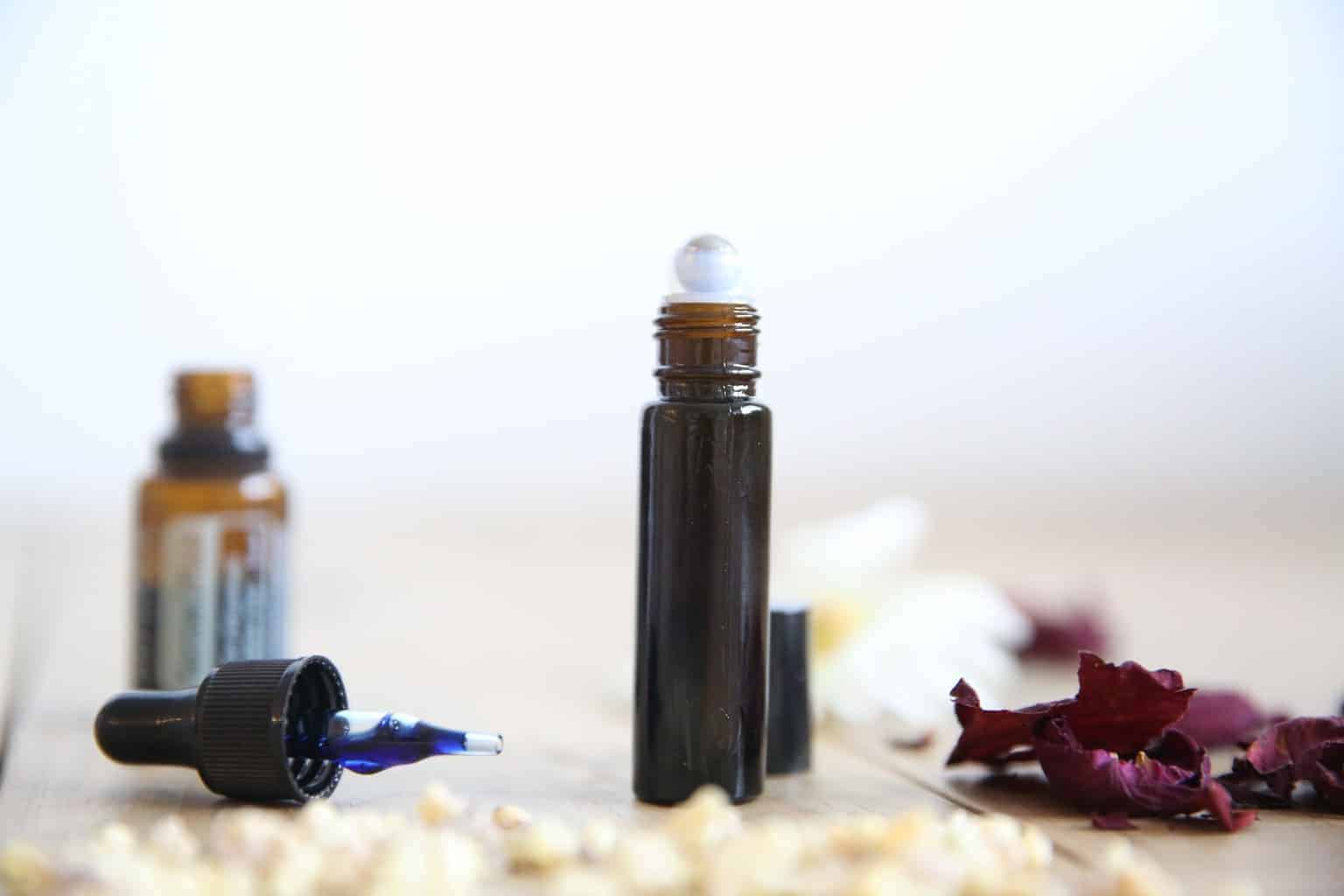 Rollerball blend for scars with essential oil dropper bottle and top.