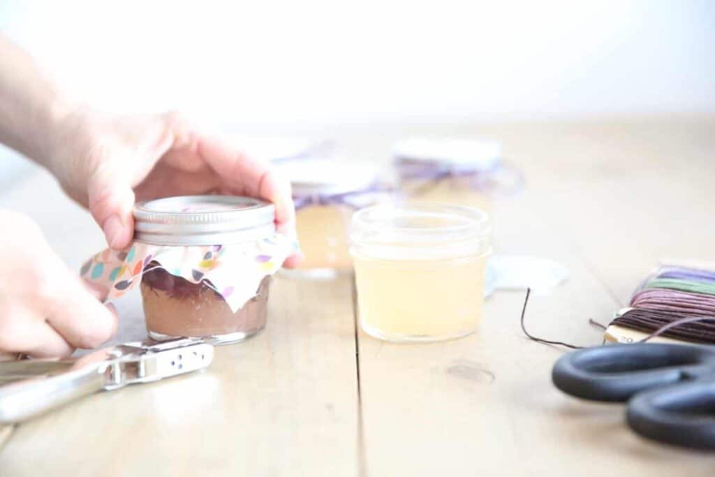 Securing the lid on a newly made air freshener.