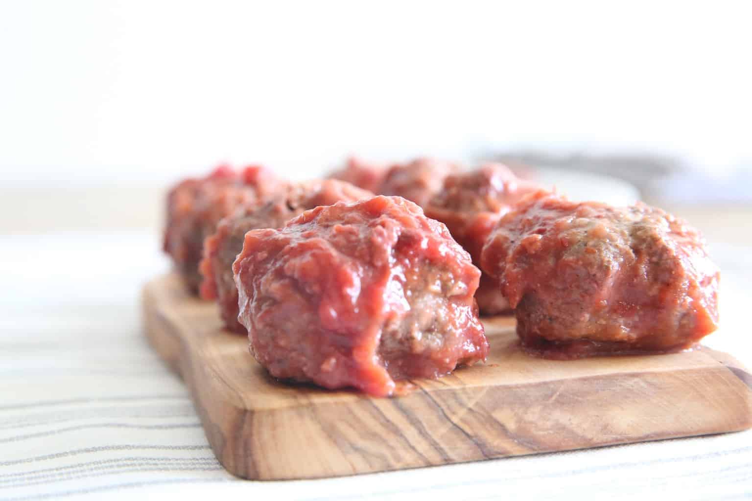 cranberry chili meatballs on cutting board 