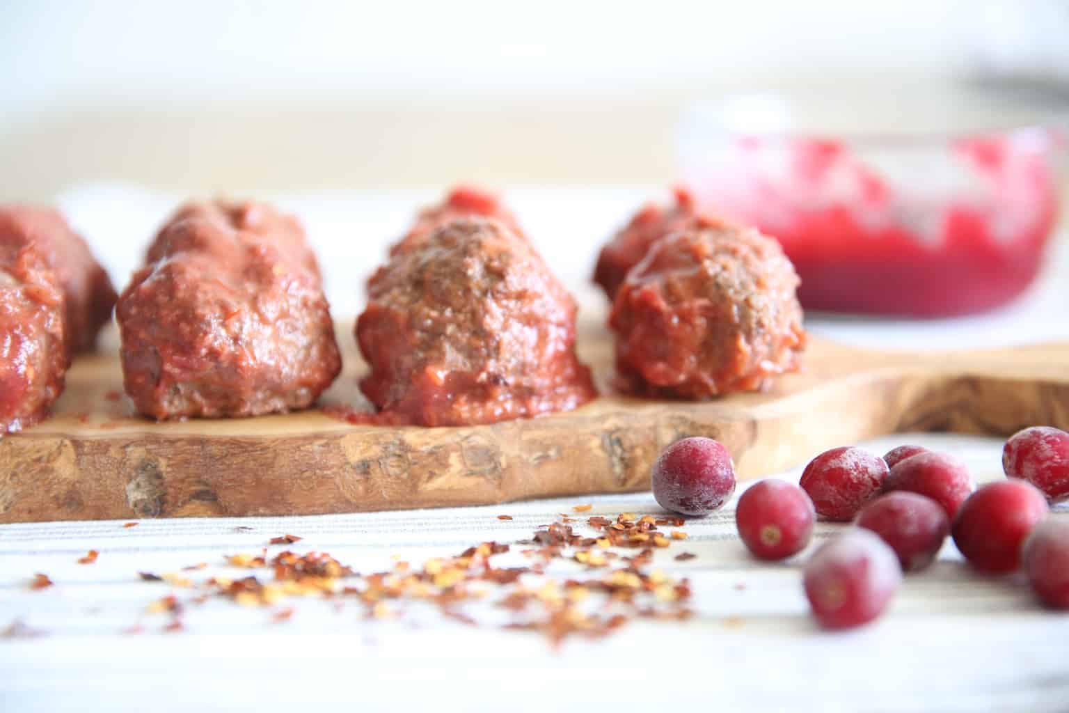 paleo cranberry chili meatballs on cutting board 