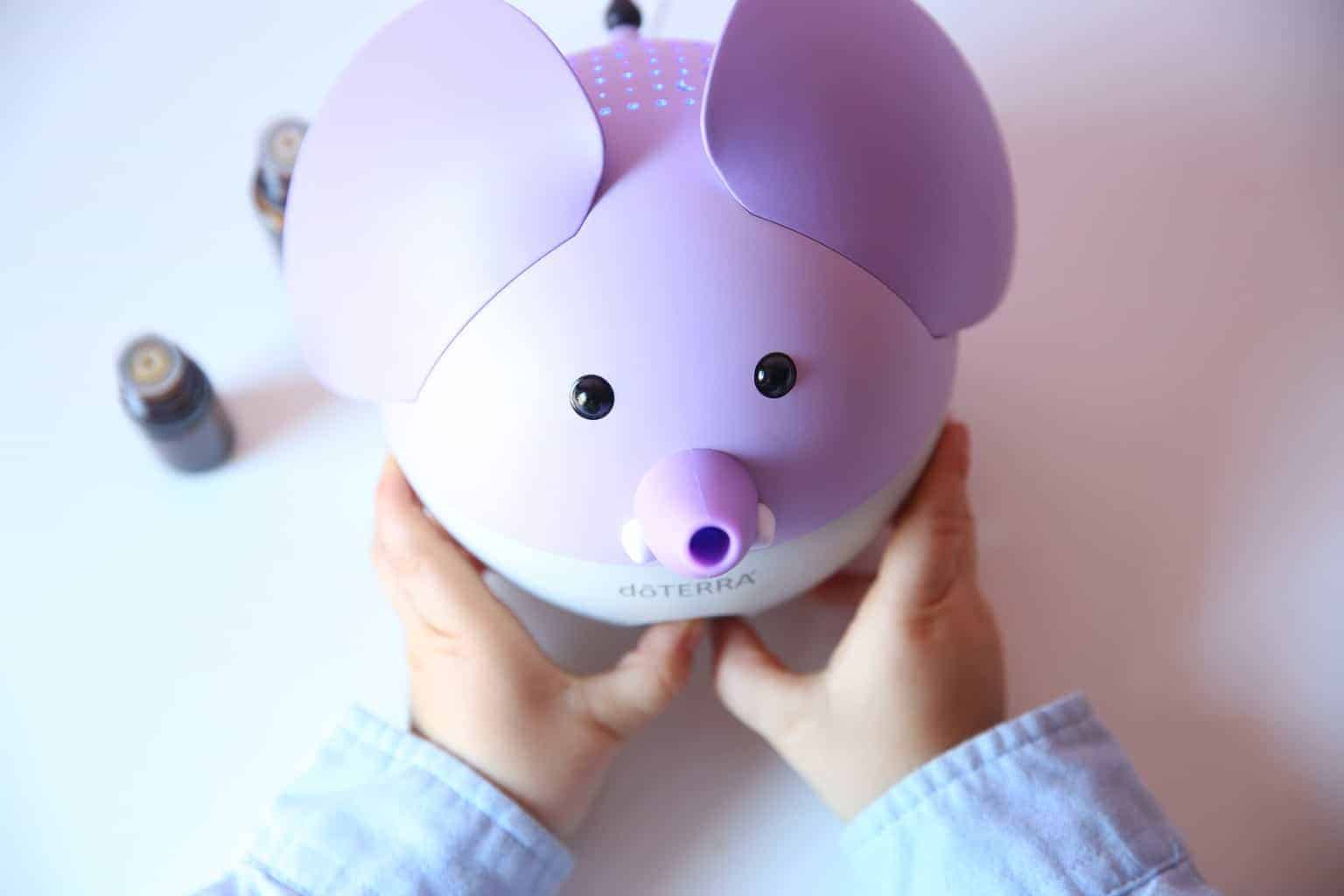 little child holding pig shaped doterra essential oil diffuser