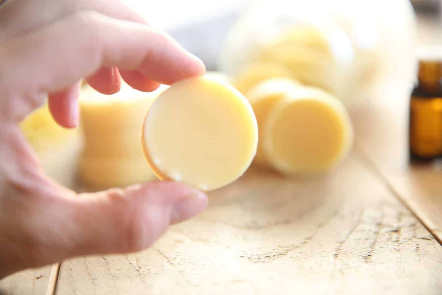 homemade lotion bar tablets on wooden table