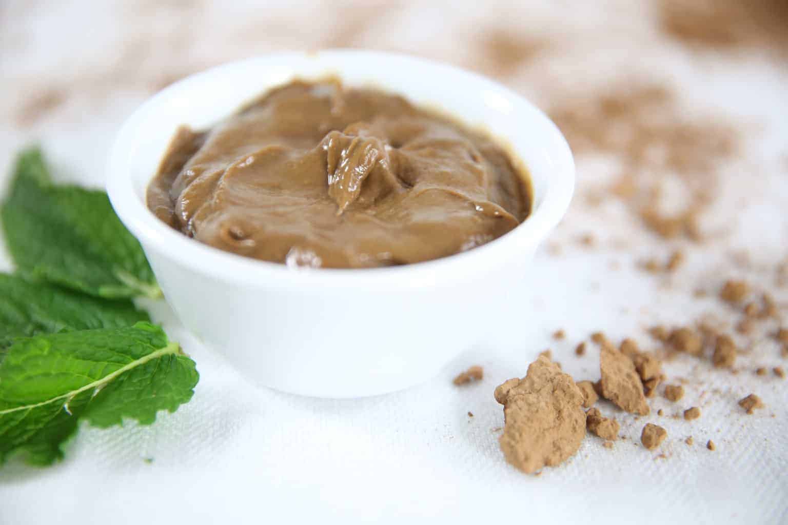 Chocolate mint avocado pudding in white bowl.