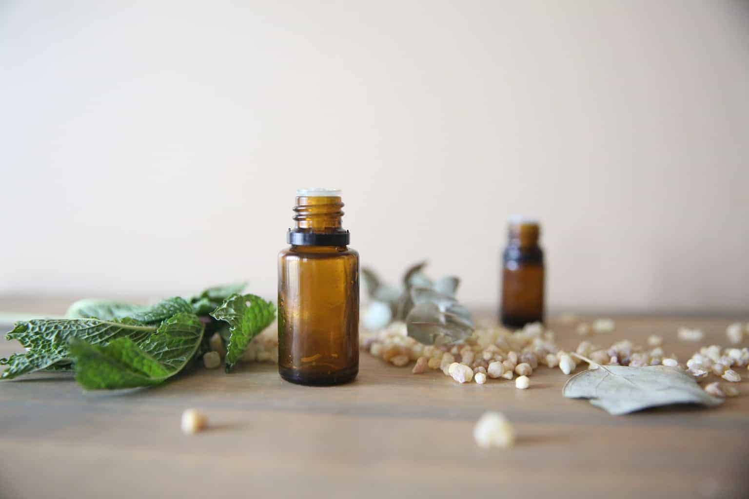 Myrrh oil bottles on wooden table.