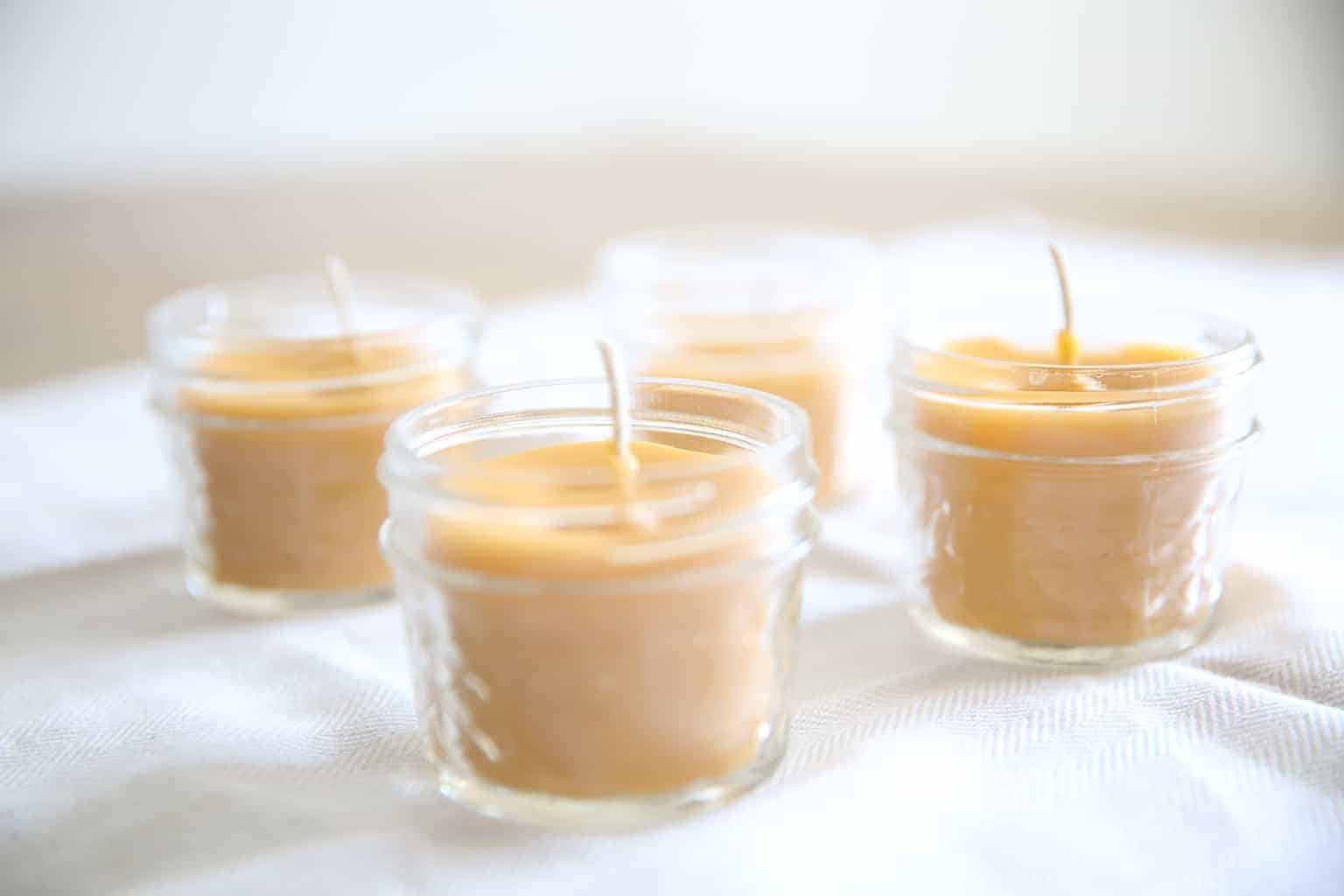 beeswax candles on white tea towel 