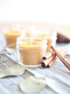 Homemade beeswax candles with cinnamon sticks.