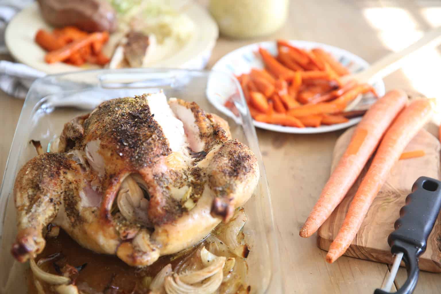 Roasted whole chicken and sliced carrots.