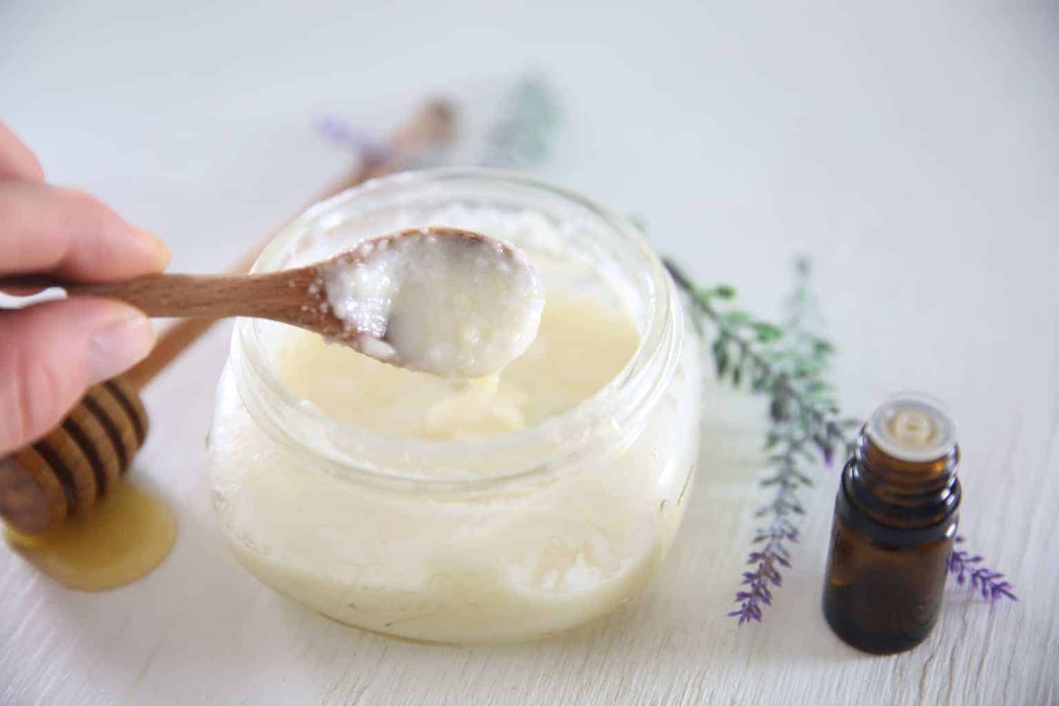 Homemade face wash in small mason jar with essential oil bottle.