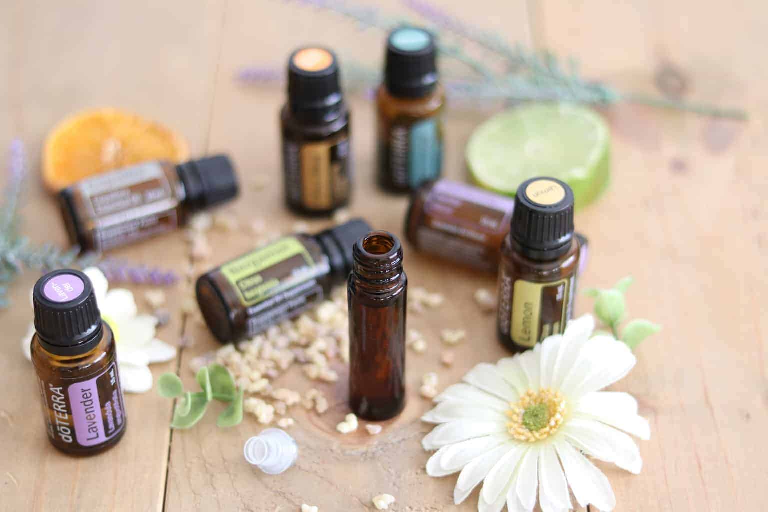 10mL roller bottle and amber colored essential oil bottles on table. 