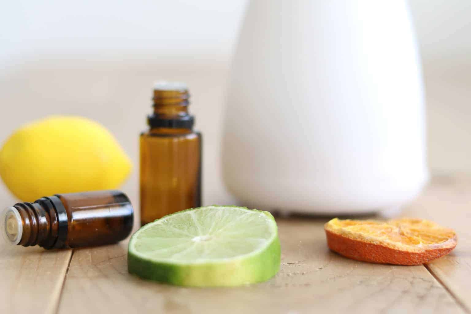 Citrus fruit on table with oil diffuser and roller bottles.