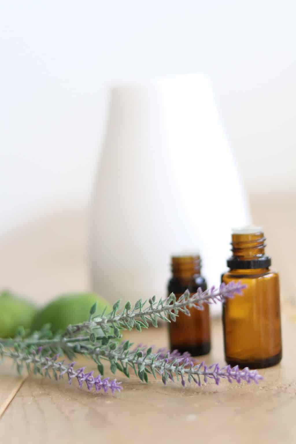 Limes, fresh lavender on table near diffuser.