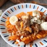 This delicious loaded sweet potato is whole 30 and paleo approved and a perfect snack for the whole family. Baked sweet potatoes with bananas, cinnamon, almonds, and almond butter.