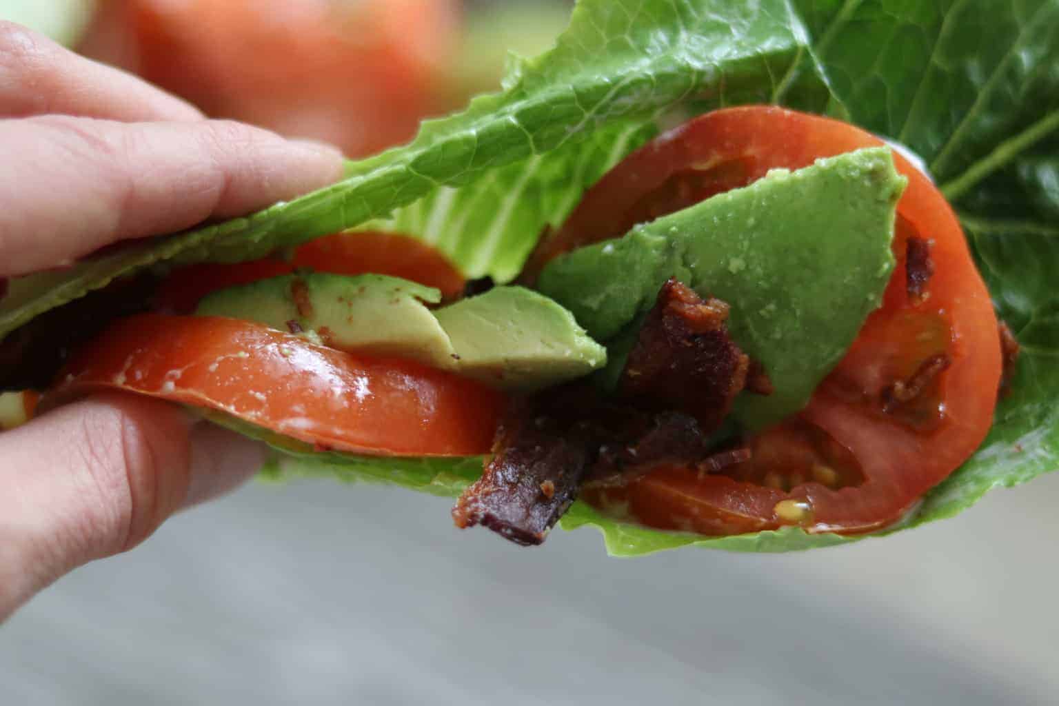 Tomatoes, avocado, and bacon rapped in lettuces. 