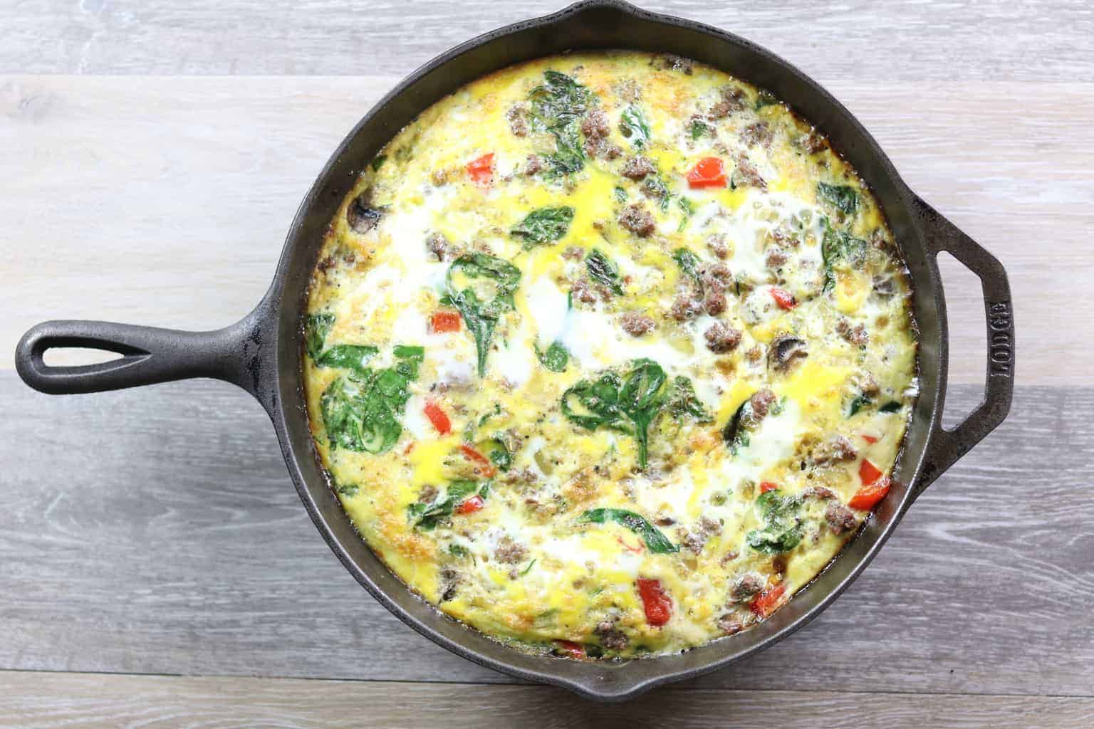 Breakfast egg casserole in cast-iron skillet.