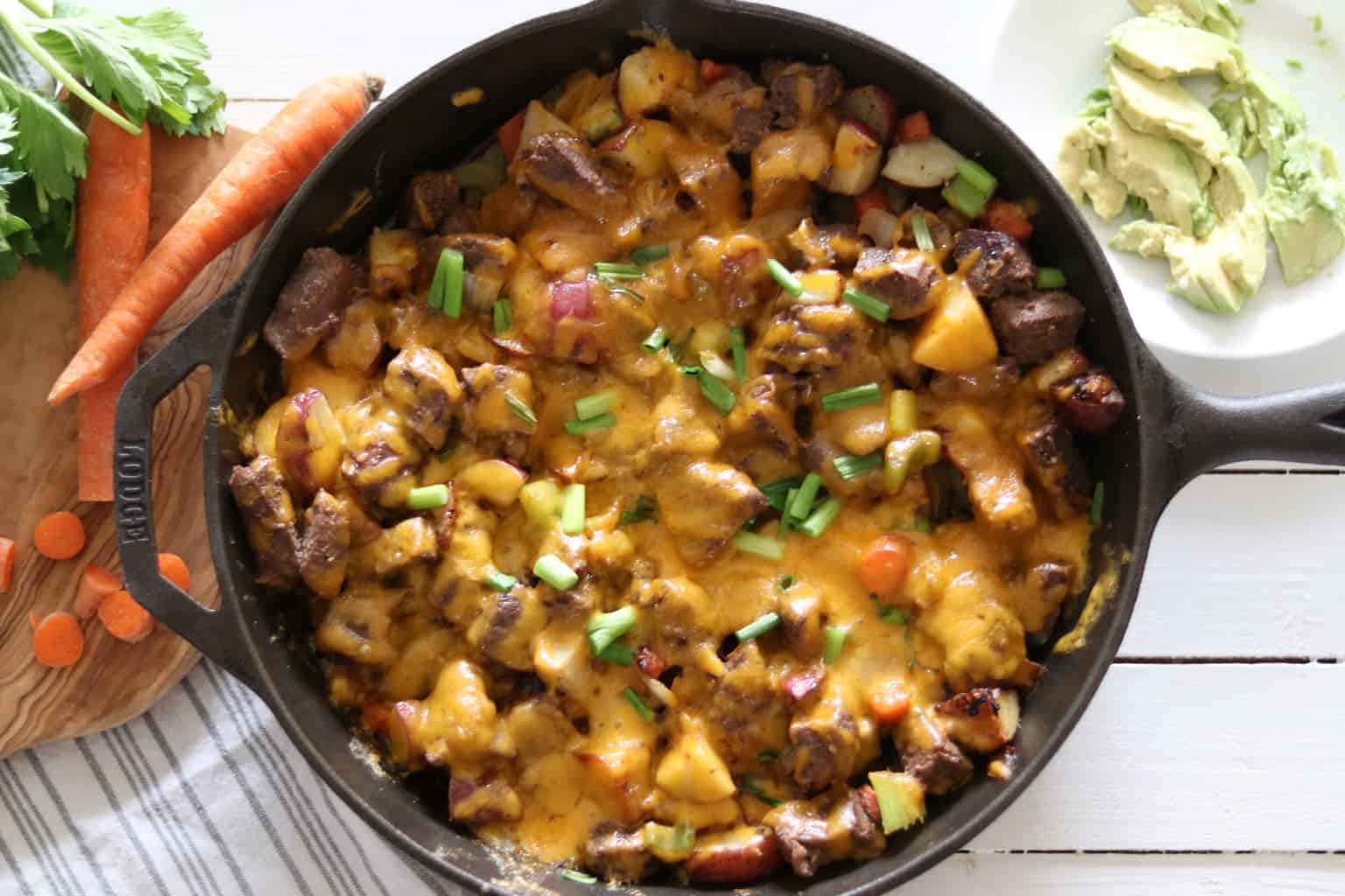 Healthy cast-iron skillet melt with garnishing on white shiplap.