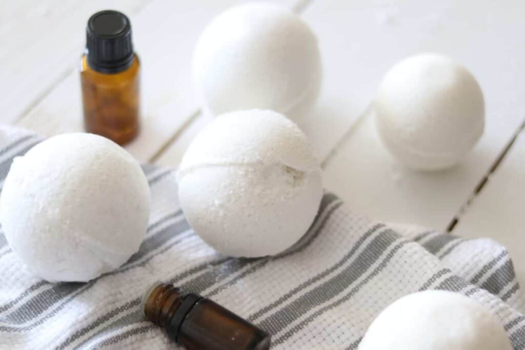 Homemade bath bombs on white shiplap.