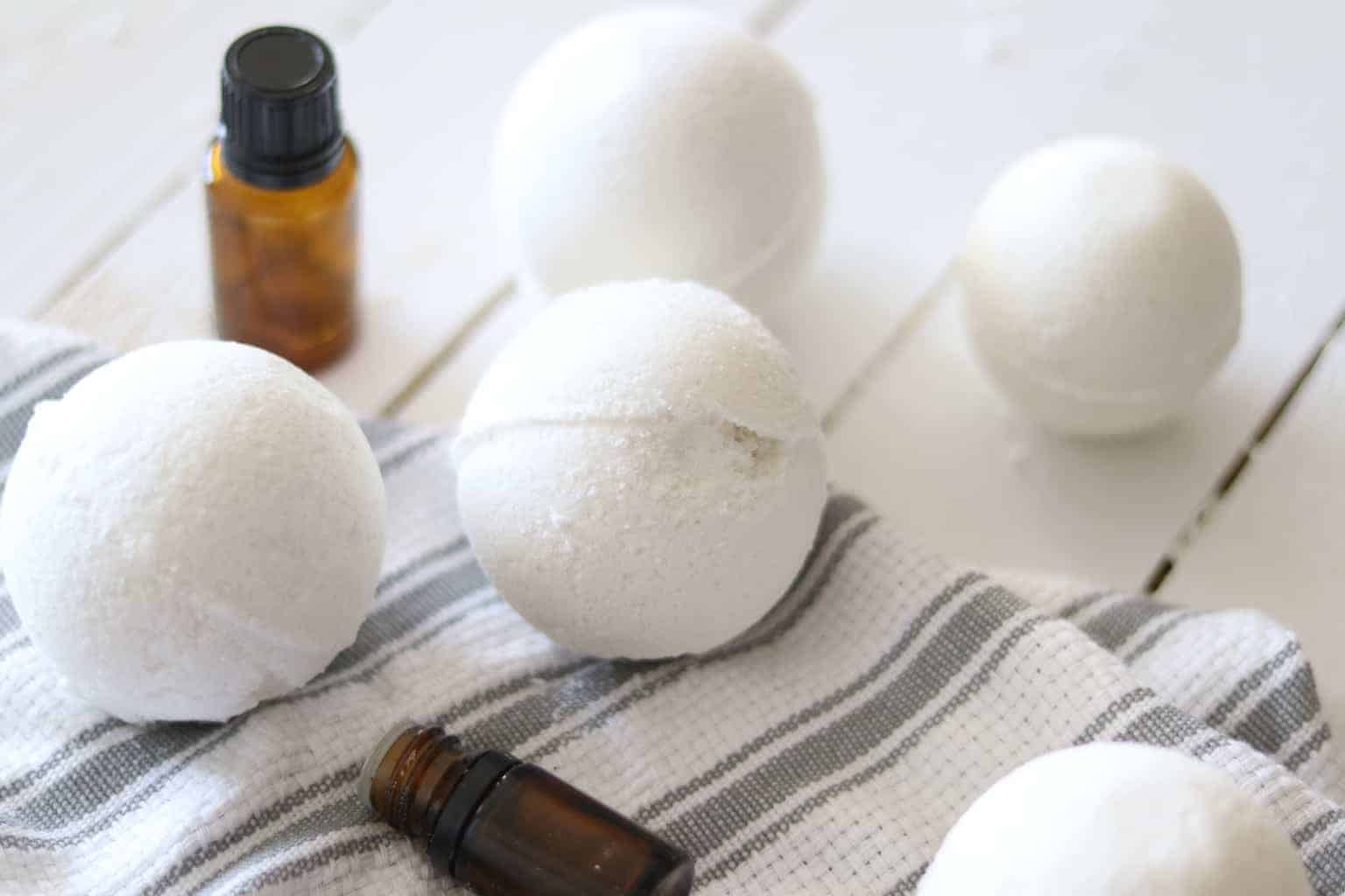 Simple Bath Bomb Recipe - Our Oily House 1 Homemade bath bombs on white shiplap.